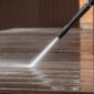 Man pressure washing wooden deck and walls 85x85