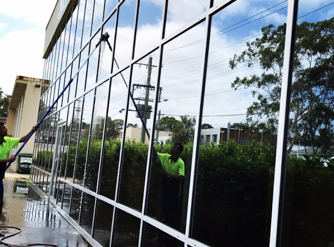 Professional window cleaners using eco-friendly methods and safe cleaning technique